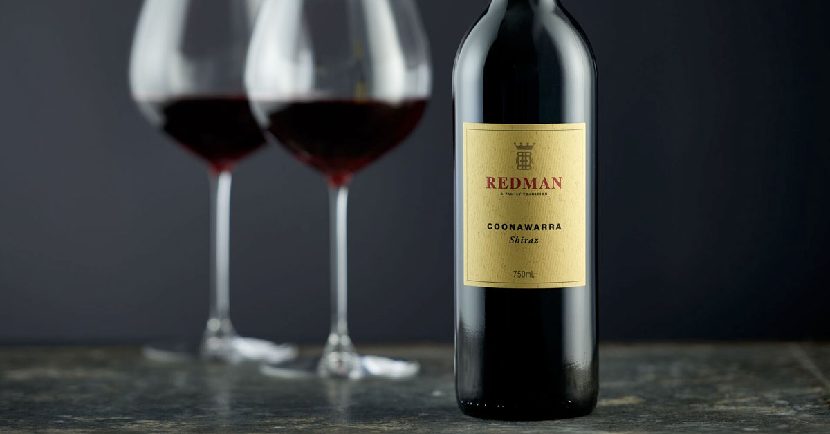 A bottle and two glasses of Redman wine