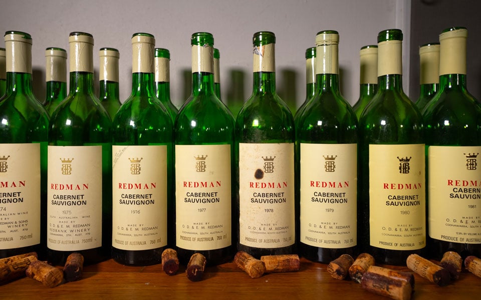 Redman wine bottles lined up on a shelf
