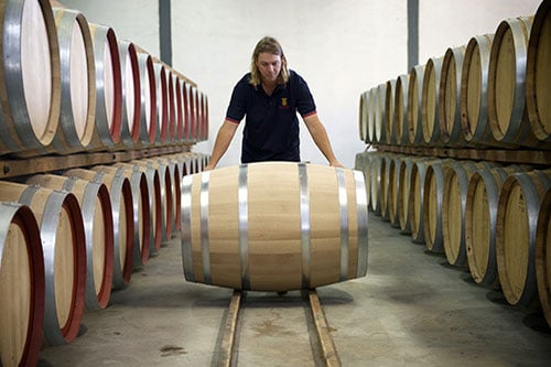 Person Rolling a wine barrel at Redman Wines