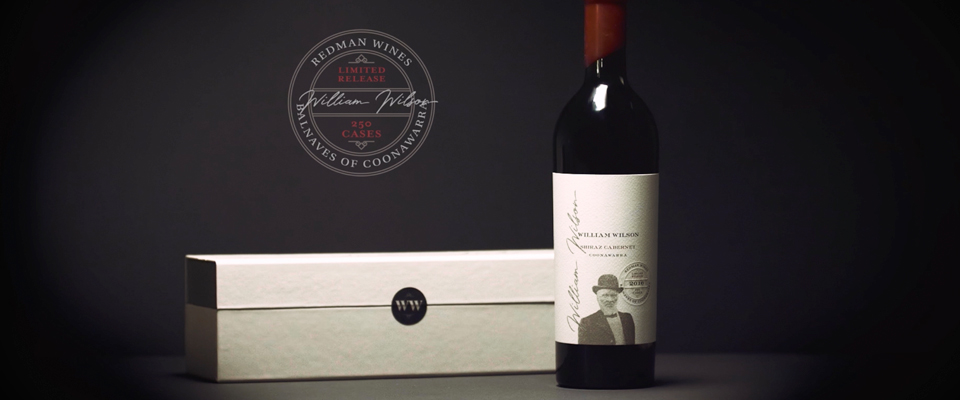 Redman wine bottle next to a box