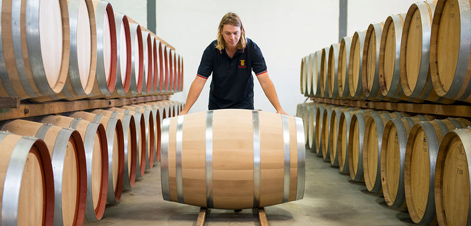 Person Rolling a wine barrel at Redman Wines