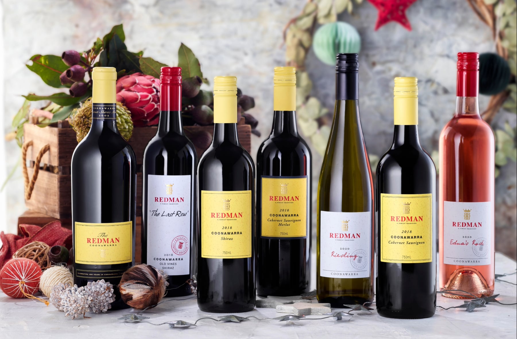 Bottles of Redman wines surrounded by Christmas decorations
